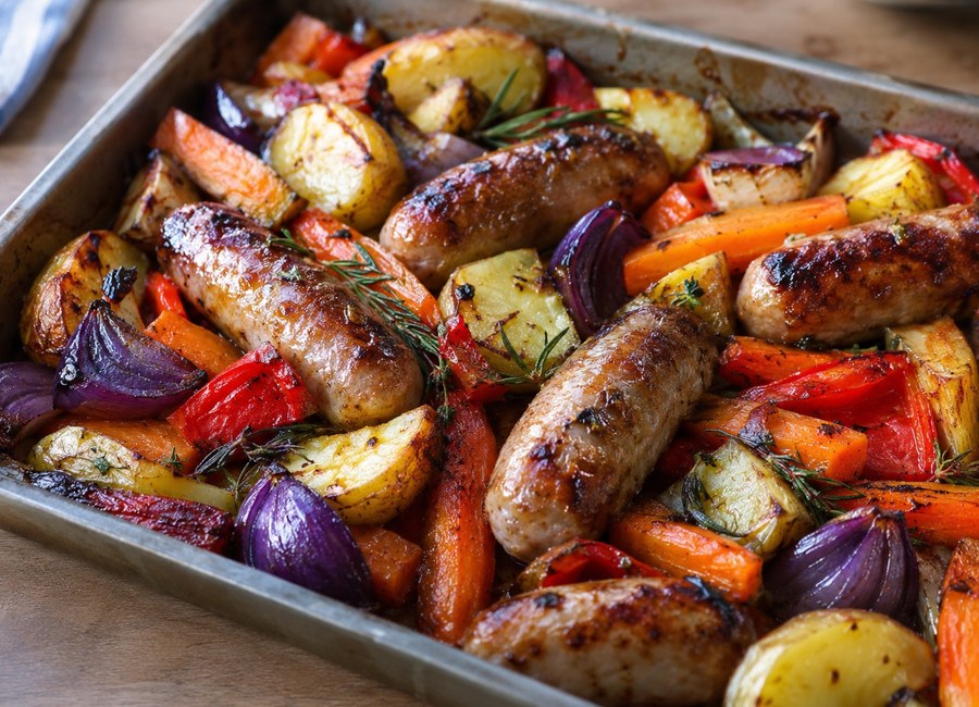 Roasted sausages with potatoes and vegetables in a traybake