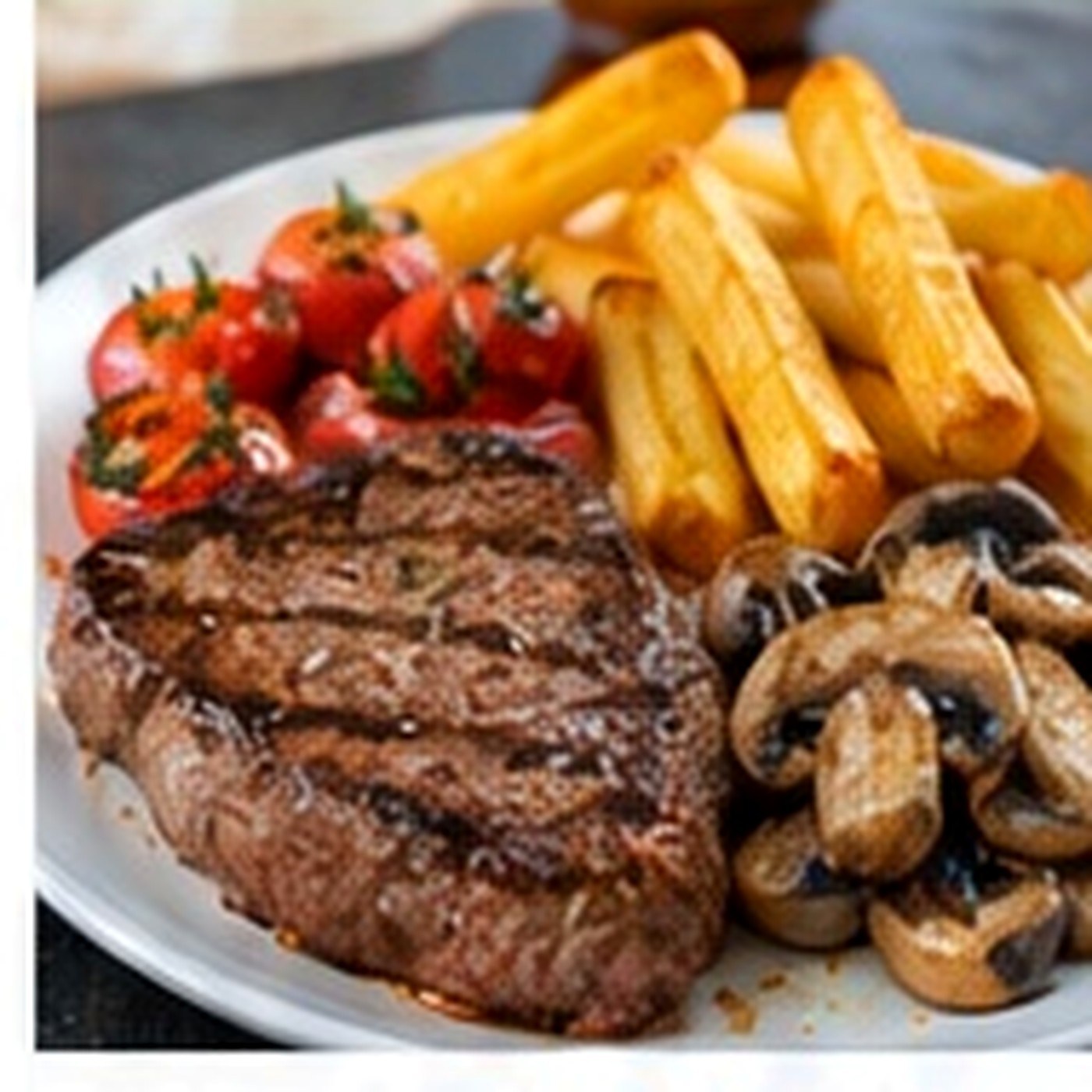 Sirloin steak with chips, mushrooms and roasted tomato